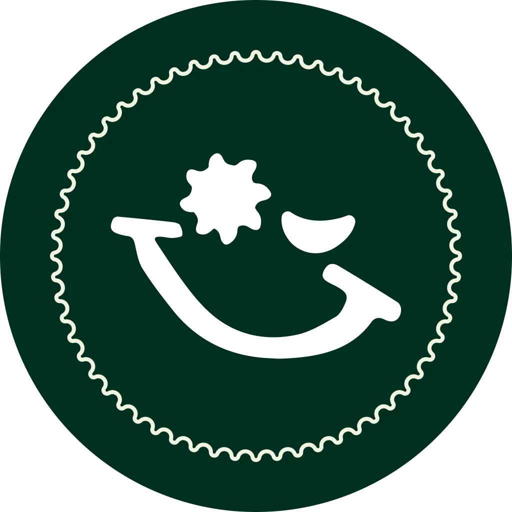 Dark green circular badge with a wavy light-colored border and a stylized black smiley face with one eye shaped like a gear and the other a crescent.